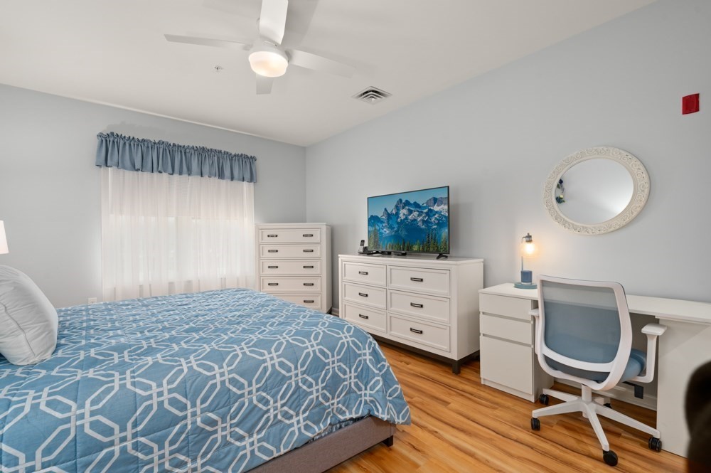 57 Augustus Court, Unit 1010 Reading, MA 01867 - Photo 22 of 32 a bedroom with a bed cabinets and chair