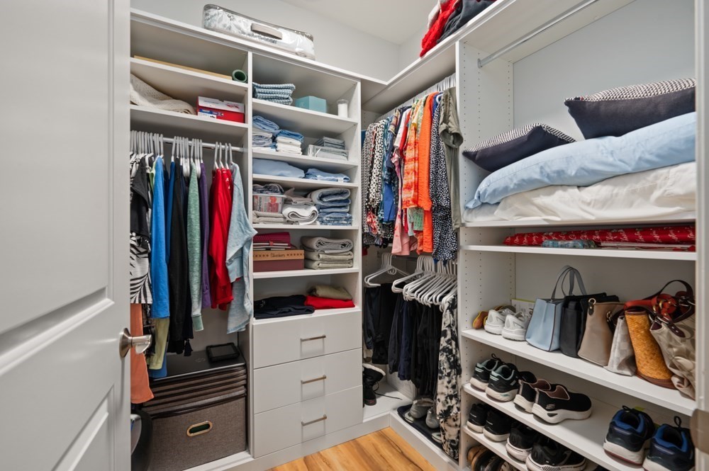 57 Augustus Court, Unit 1010 Reading, MA 01867 - Photo 23 of 32 a view of walk in closet with clothes and shoes
