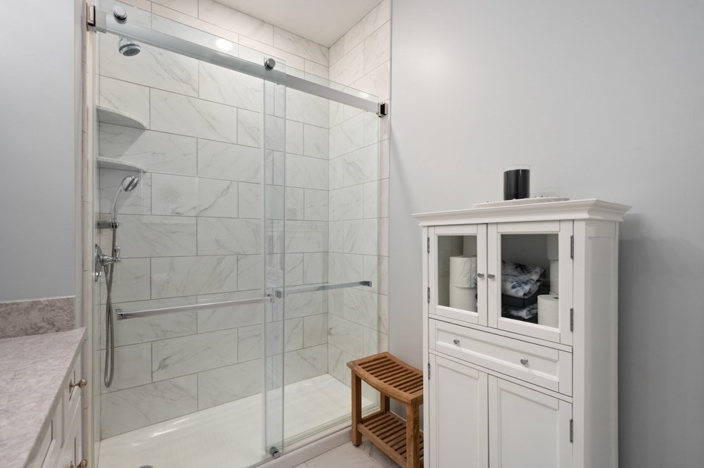 57 Augustus Court, Unit 1010 Reading, MA 01867 - Photo 25 of 32 a bathroom with a shower and a sink