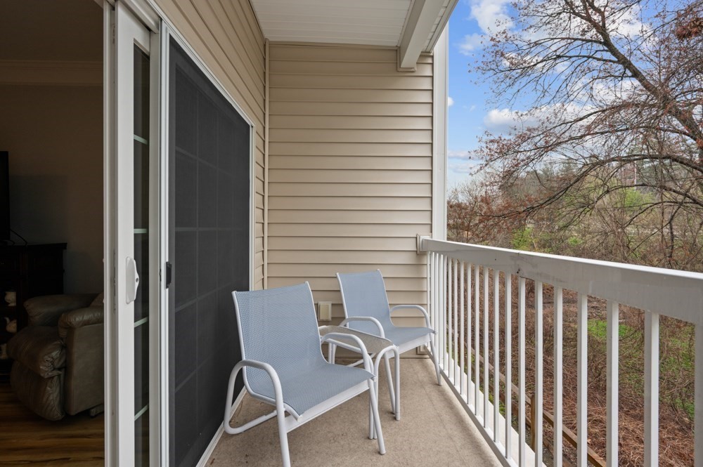 57 Augustus Court, Unit 1010 Reading, MA 01867 - Photo 27 of 32 a view of a chair and table in the balcony