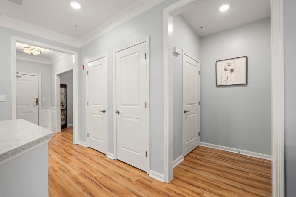 57 Augustus Court, Unit 1010 Reading, MA 01867 - Photo 6 of 32 a view of a hallway with wooden floor