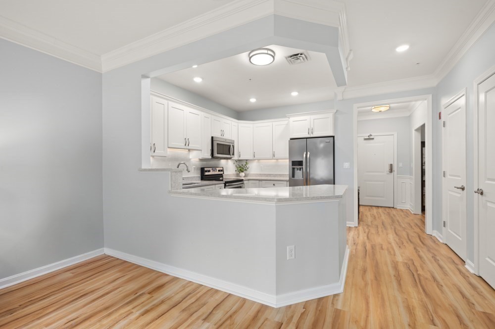 57 Augustus Court, Unit 1010 Reading, MA 01867 - Photo 7 of 32 a kitchen with stainless steel appliances granite countertop a refrigerator and a sink