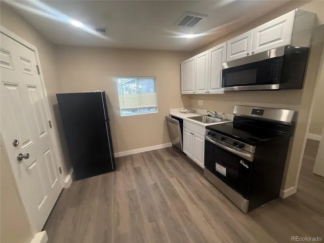 a kitchen with wooden cabinets and black appliances