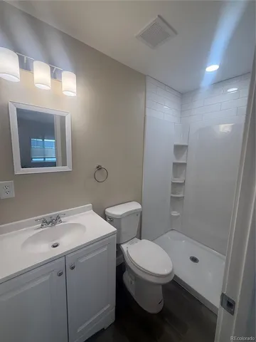 a bathroom with a toilet sink and shower