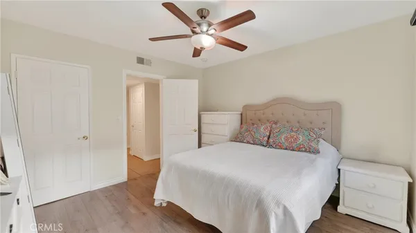 a bedroom with a bed and a ceiling fan