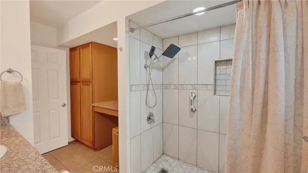 a bathroom with a shower and a glass door
