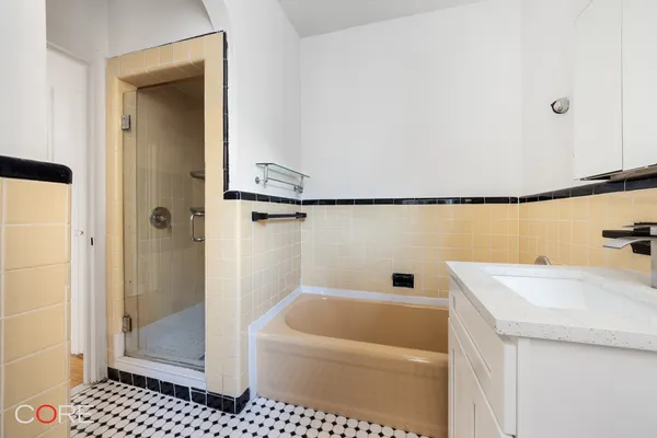 a bathroom with a sink a toilet and a shower