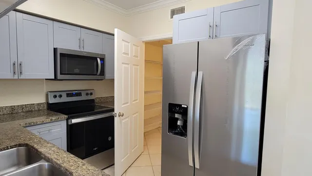 a kitchen with a refrigerator stove and microwave