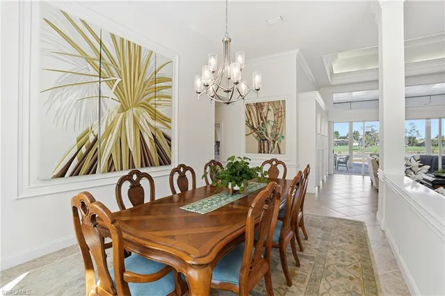 a dining room with furniture a chandelier and a rug