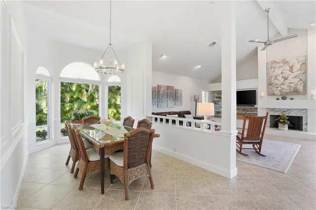 a dining room with furniture a chandelier and a rug