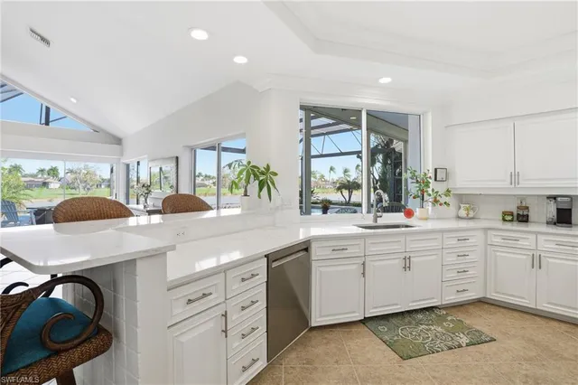 a kitchen with a sink a stove and cabinets