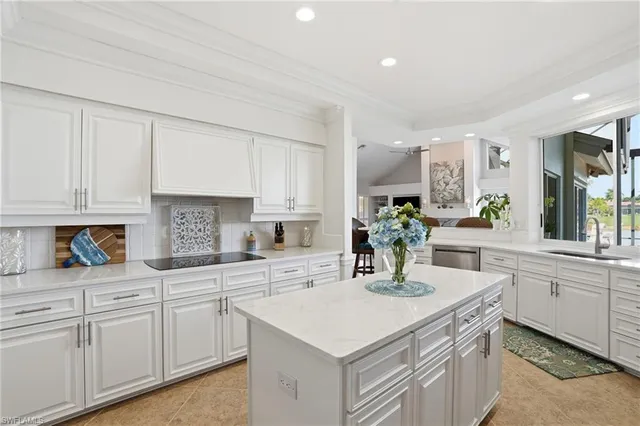 a kitchen with white cabinets and a sink