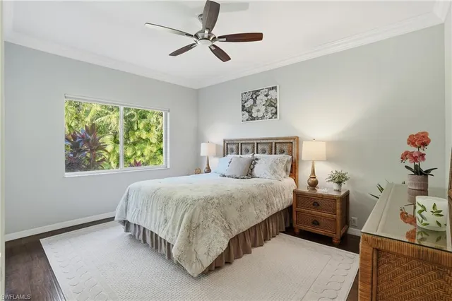 a bedroom with a bed and a tv on the dresser
