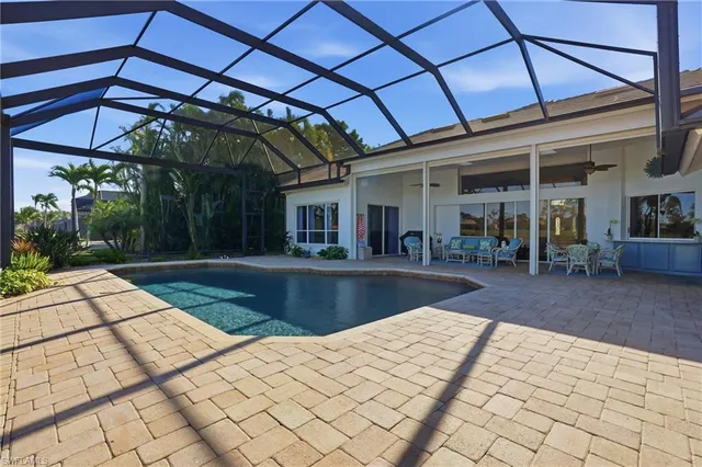 a view of a balcony with chairs and a potted plant
