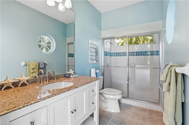 a view of a patio with a table and chairs under an umbrella