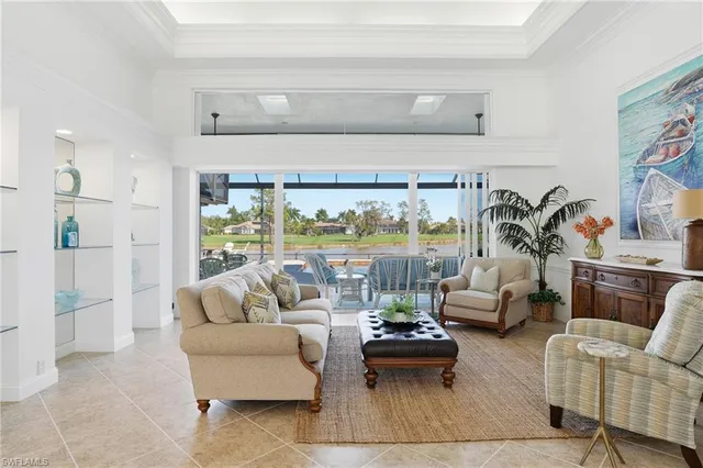 a living room with furniture and a floor to ceiling window