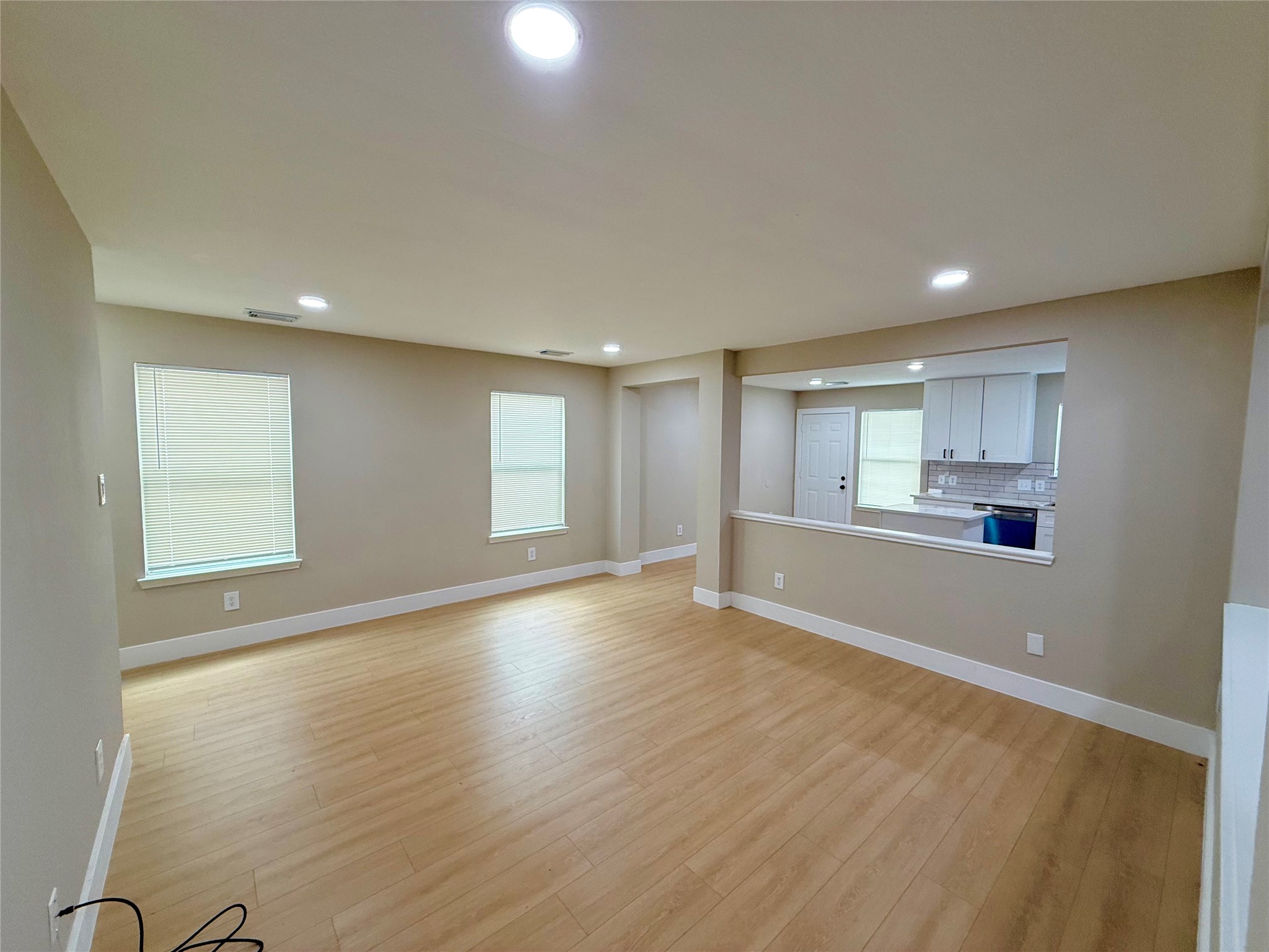 3819 Banks Ridge Lane Katy, TX 77449 - Photo 4 of 13 a view of an empty room with wooden floor and a window