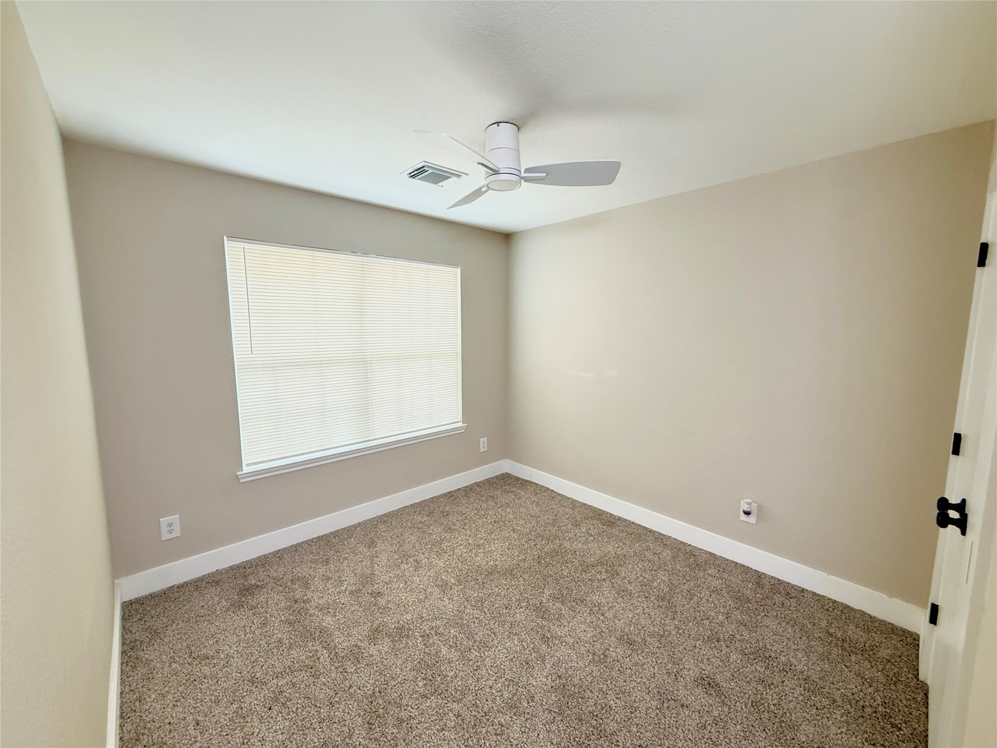 3819 Banks Ridge Lane Katy, TX 77449 - Photo 6 of 13 an empty room with a window and a fan