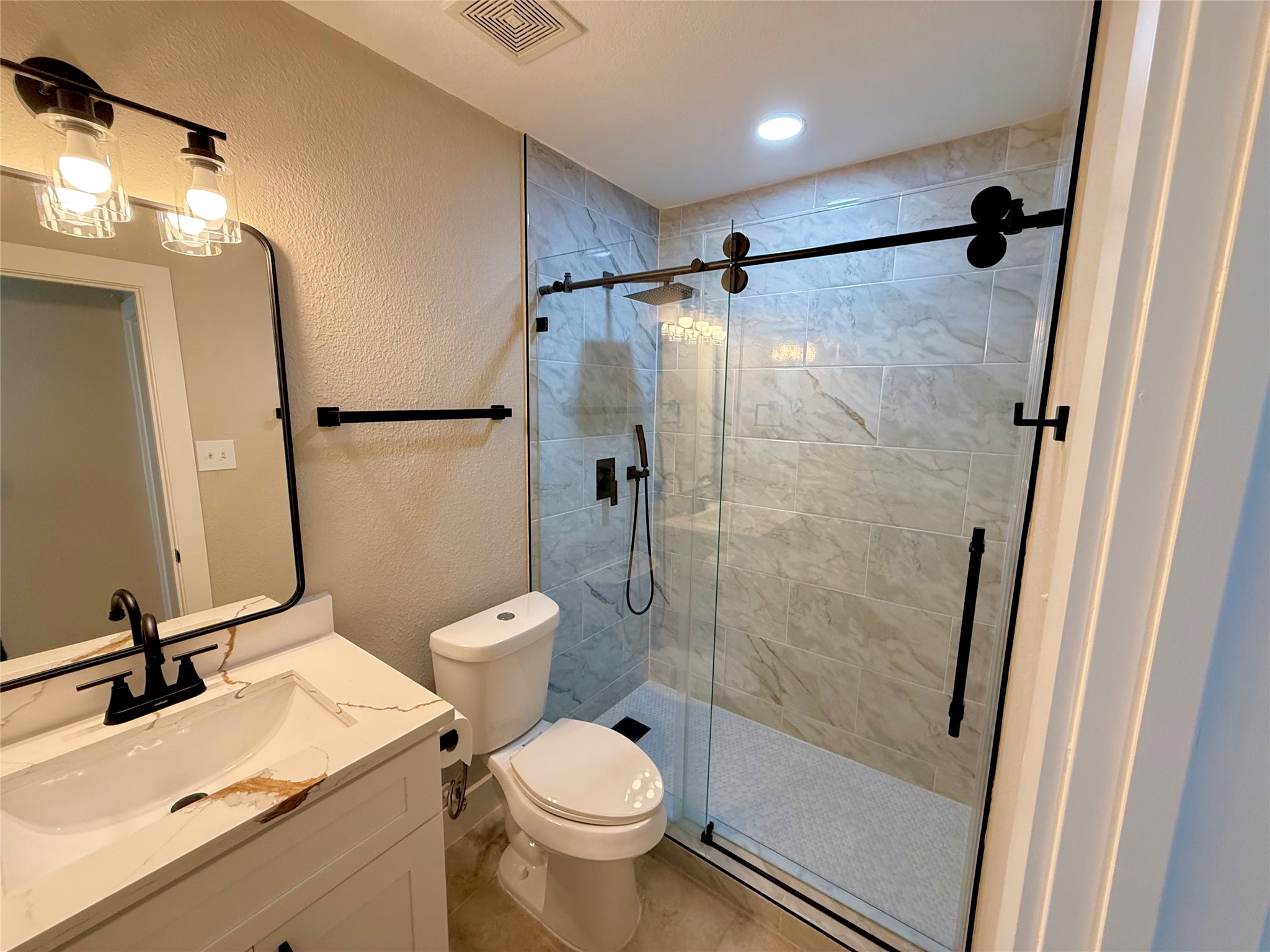 3819 Banks Ridge Lane Katy, TX 77449 - Photo 8 of 13 a bathroom with a toilet sink and a shower