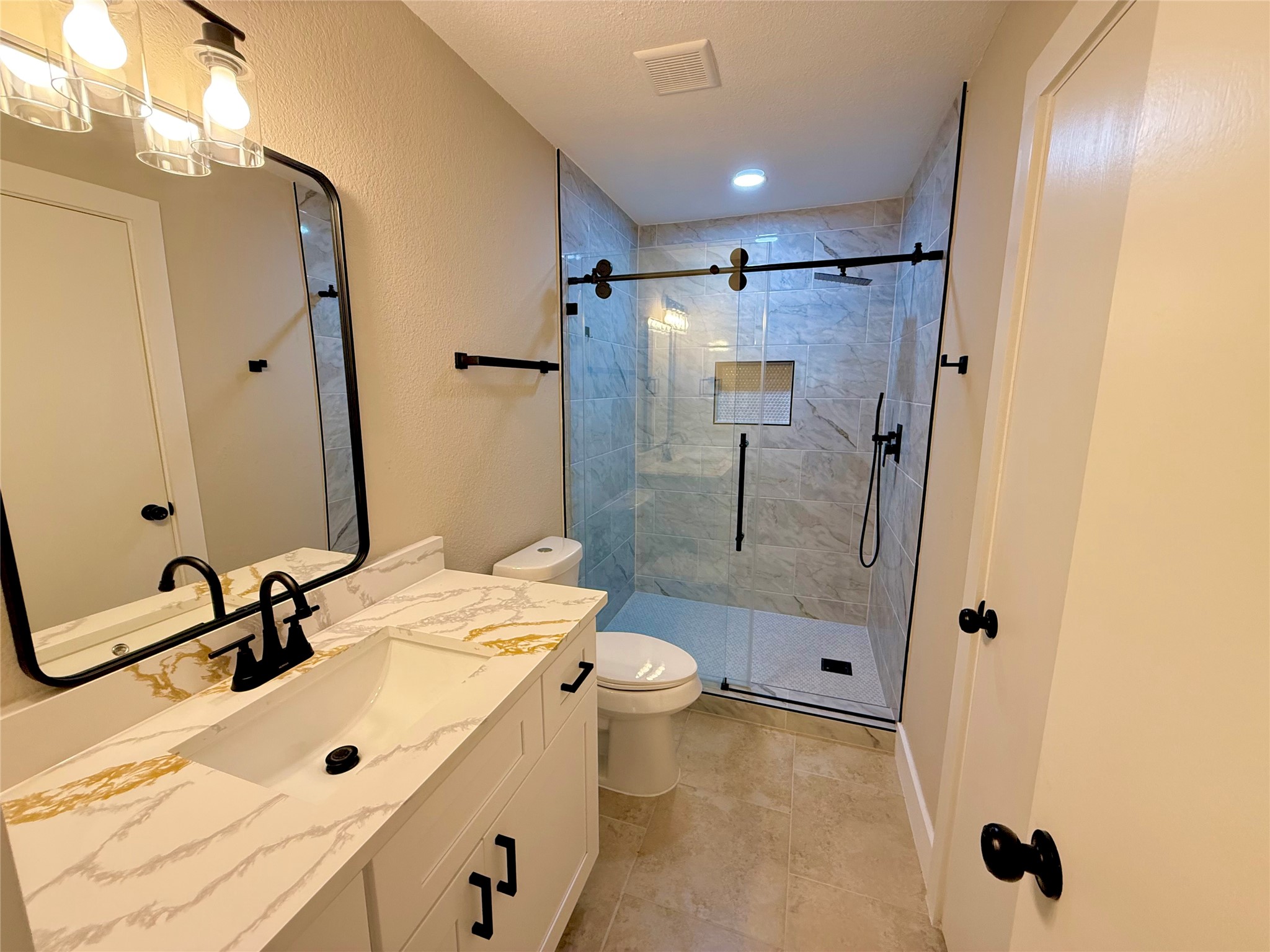 3819 Banks Ridge Lane Katy, TX 77449 - Photo 10 of 13 a bathroom with a sink a toilet and shower