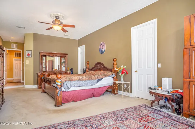 a bed room with a bed and a chair