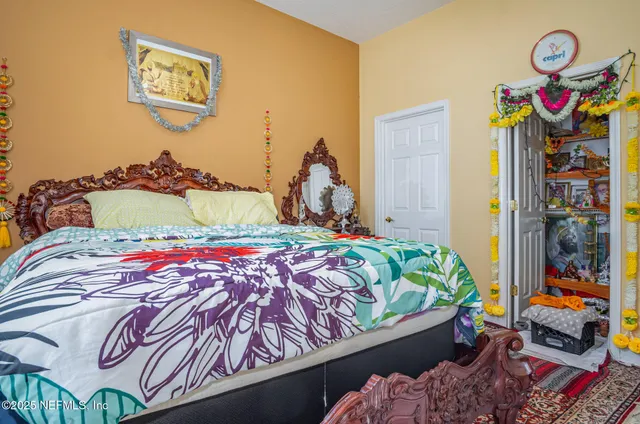 a bedroom with bed and wooden floor