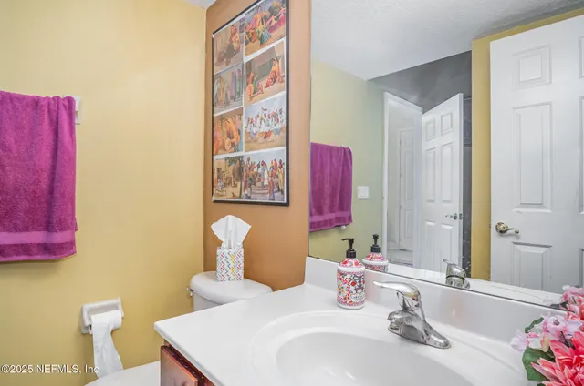 a bathroom with a sink vanity and a mirror