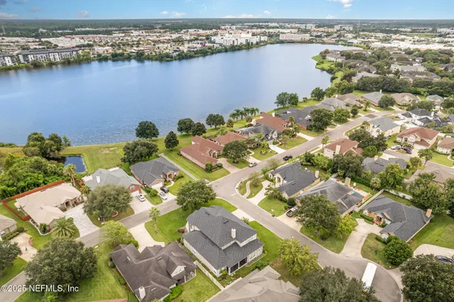 an aerial view of a house with a lake view