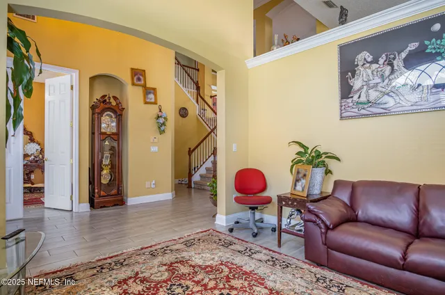 a living room with furniture and wooden floor