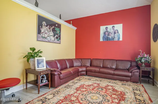 a living room with furniture a couch and a potted plant