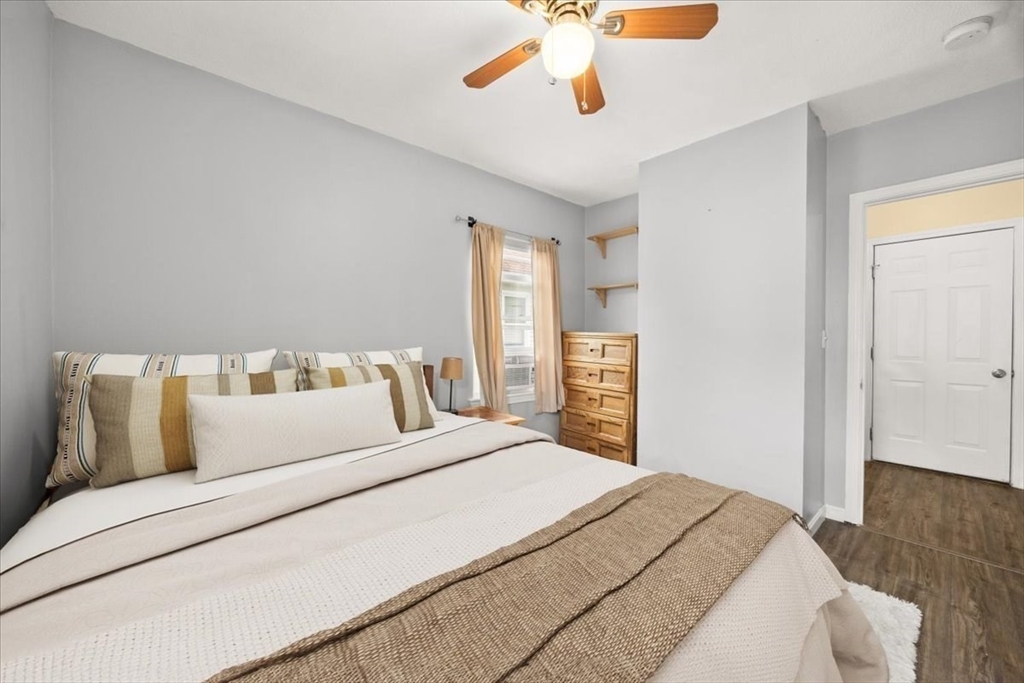 35 Hazel Street, Unit B Attleboro, MA 02703 - Photo 11 of 21 a bedroom with a large bed and a chandelier