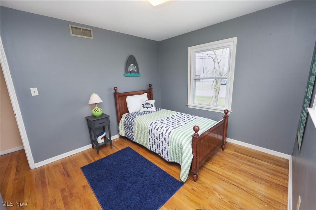 2674 Smith Road Fairlawn, OH 44333 - Photo 19 of 31 Bedroom with visible vents, baseboards, and wood finished floors