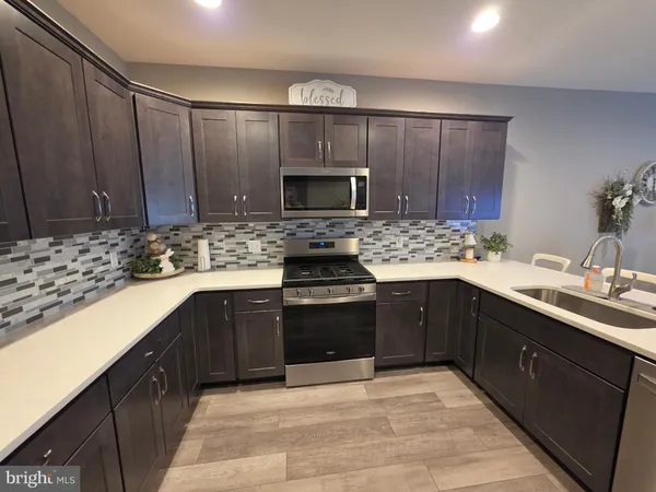 a kitchen with a sink stove and cabinets