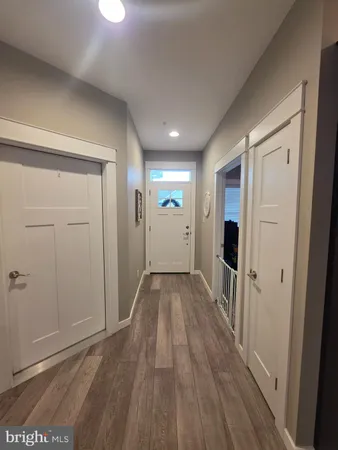 a view of hallway with wooden floor