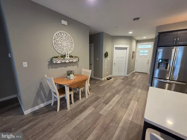 a view of a dining room with furniture and wooden floor