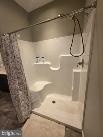 a bathroom with a shower and a sink