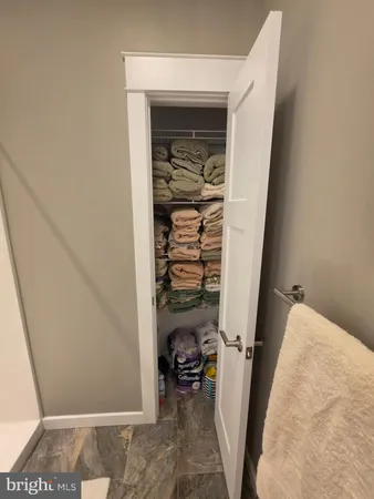 a view of walk in closet with clothes