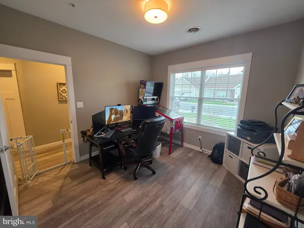 a view of a workspace with furniture and a window