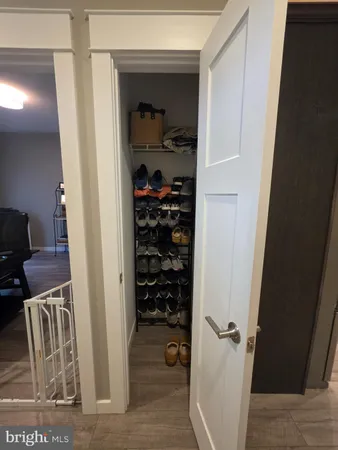 a view of a hallway with closet and couch