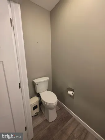 a white toilet sitting next to a sink