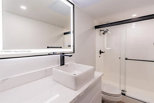 a white bath tub sitting next to a white sink and a washer