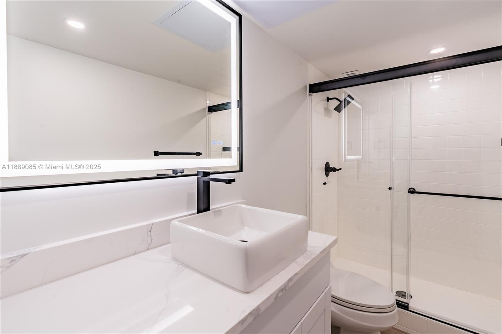 2030 South Ocean Drive, Unit 1127 Hallandale Beach, FL 33009 - Photo 12 of 39 a white bath tub sitting next to a white sink and a washer