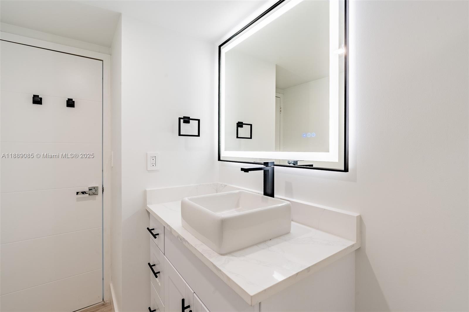 2030 South Ocean Drive, Unit 1127 Hallandale Beach, FL 33009 - Photo 13 of 39 a bathroom with a sink and a mirror