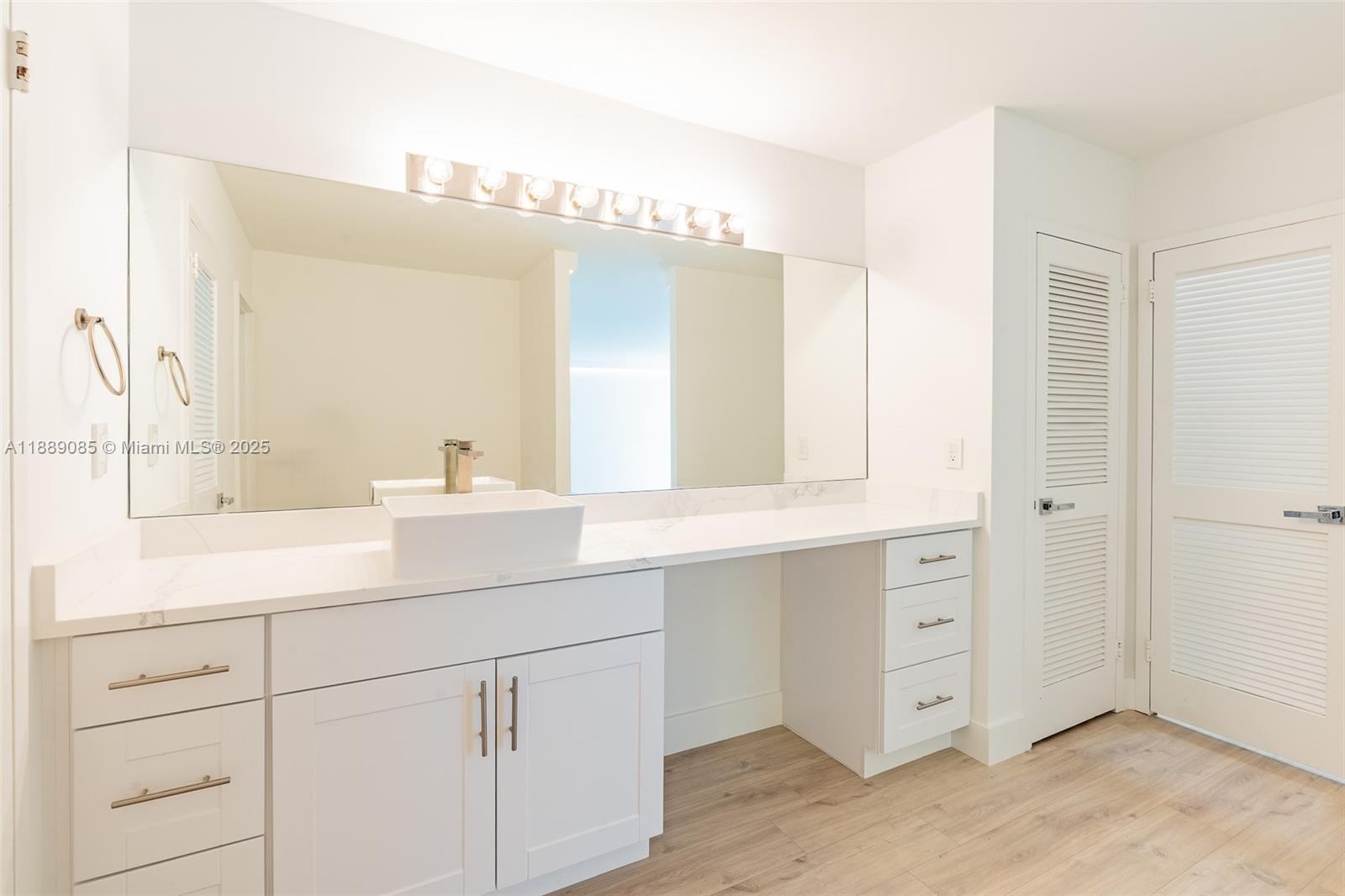 2030 South Ocean Drive, Unit 1127 Hallandale Beach, FL 33009 - Photo 16 of 39 a bathroom with a sink vanity and mirror