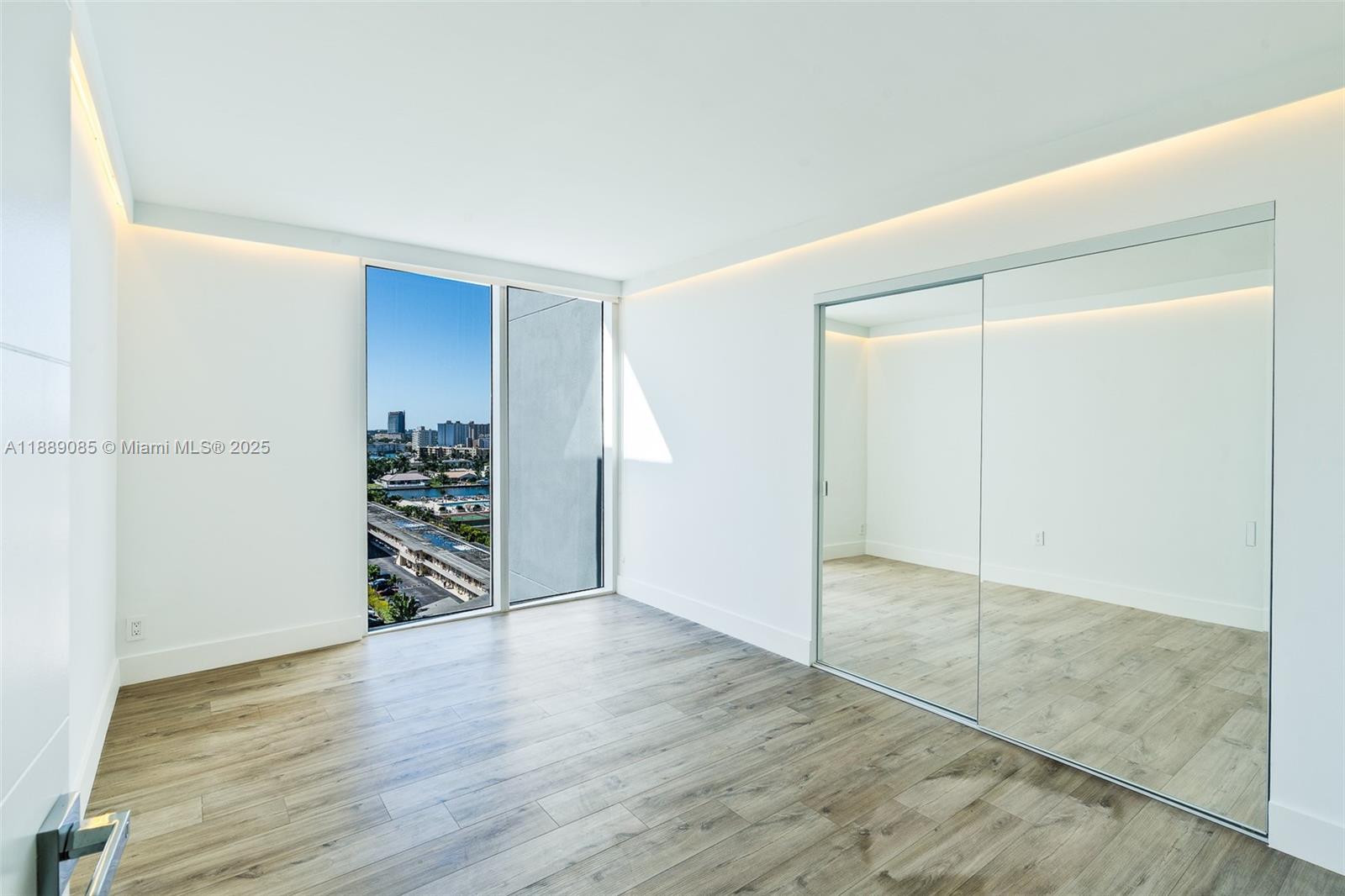 2030 South Ocean Drive, Unit 1127 Hallandale Beach, FL 33009 - Photo 8 of 39 an empty room with wooden floor and closet