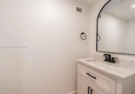 a bathroom with a sink and vanity