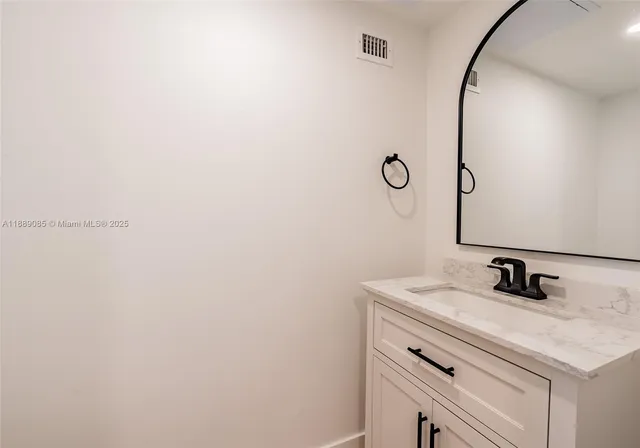 a bathroom with a sink and vanity