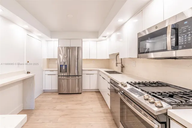 a kitchen with a stove sink and refrigerator