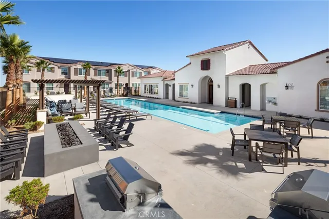 a living room with furniture a rug and a chandelier