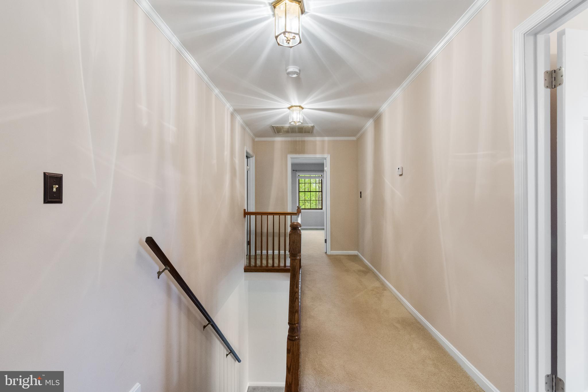 4036 Roop Road New Windsor, MD 21776 - Photo 24 of 55 a view of a hallway with windows and chandelier